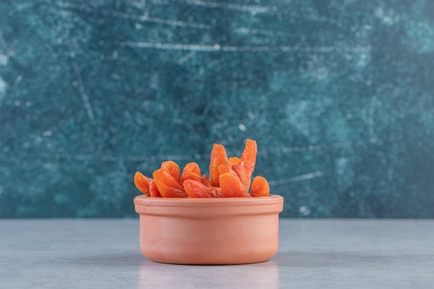 Close-up shot of various pre-portioned snacks in reusable containers. The snacks include carrot sticks with hummus, apple slices with almond butter, and trail mix with nuts, seeds, and dried cranberries. The image emphasizes the convenience and portability of pre-prepped snacks.