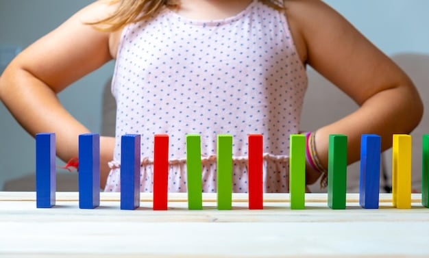 A close-up shot of a child deeply engrossed while playing with building blocks. The child displays intense focus, showing the positive impact of toy rotation on concentration and engagement.