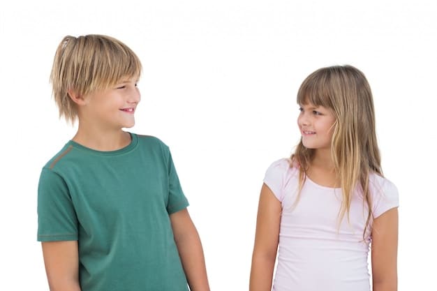 Two young children, a boy and a girl, are playing 