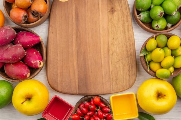 Overhead shot of a grocery list and a colorful assortment of fresh fruits and vegetables arranged on a wooden table, ready to be prepped for snacks. A set of reusable containers is also visible.
