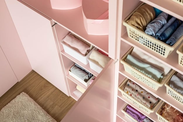 A well-organized closet interior, showcasing various storage solutions like shelves, hanging rods, drawers, and bins. The clothes are neatly folded and arranged by color and type.