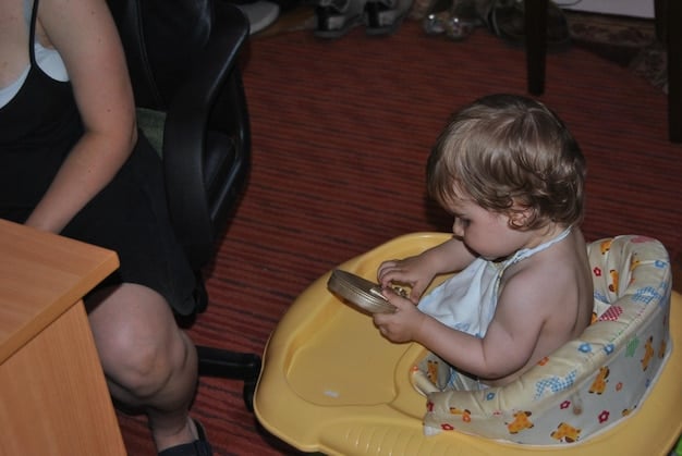 A close-up shot of a toddler pointing at a potty chair with a curious and engaged expression. The toddler seems interested in the potty training process.