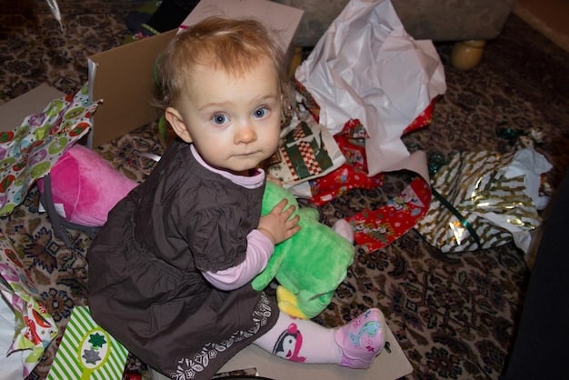 A photograph showcasing a landfill overflowing with plastic waste, with a focus on discarded baby food pouches and containers. The image emphasizes the scale of the pollution problem caused by non-sustainable packaging.