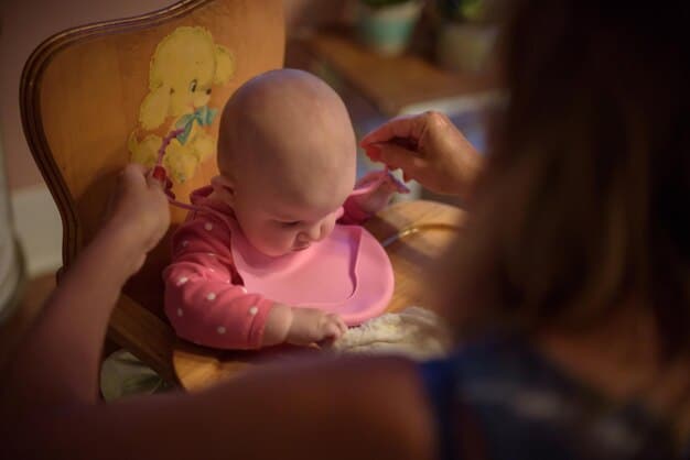 A parent attentively watching their baby during baby-led weaning, with both making eye contact and smiling. The focus is on the interactive and supervised nature of the feeding process.