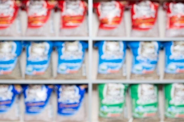 A side-by-side comparison shot of supermarket shelves filled with baby food jars and pouches. On one side, products are labeled 