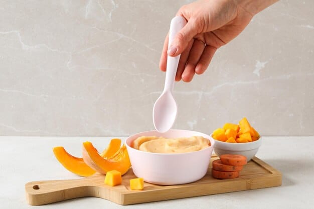 A parent mashing cooked sweet potato on a plate with a fork, demonstrating how to check for appropriate texture before feeding a baby. The background is a bright, clean kitchen setting.