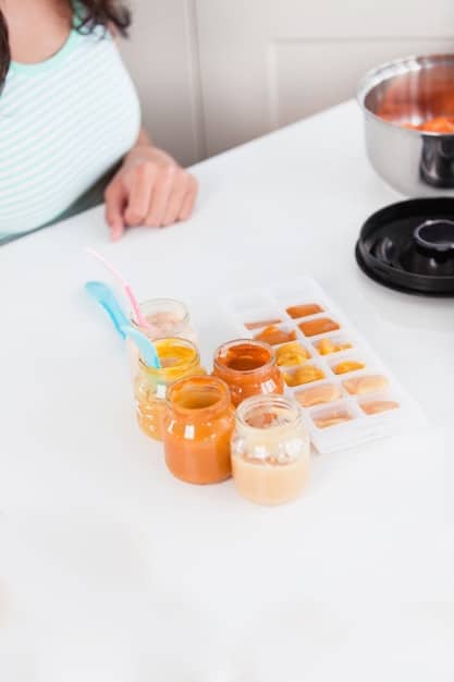 A parent carefully placing small portions of homemade baby food puree into a silicone freezer tray, using a spoon, in a brightly lit kitchen.