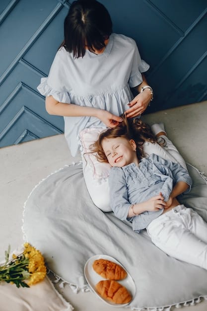 A mother sitting comfortably with her eyes closed, practicing a guided meditation while her baby sleeps peacefully nearby, promoting relaxation and stress reduction.