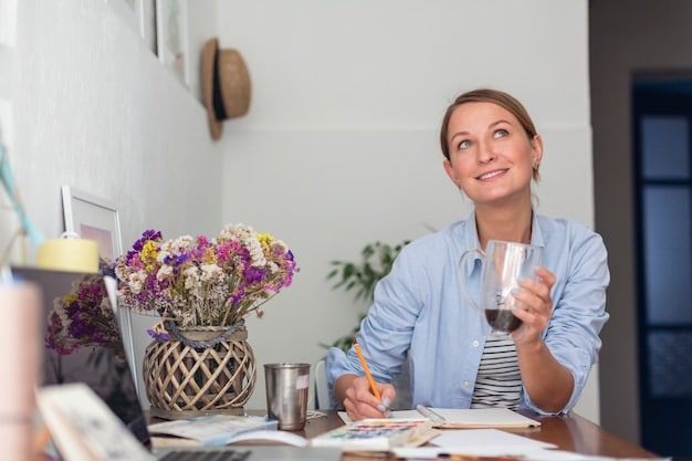 A mom is sitting at a desk with a notebook and pen, looking thoughtful and focused. She is writing down her goals for the day. A cup of coffee sits nearby, and the room is organized and bright.
