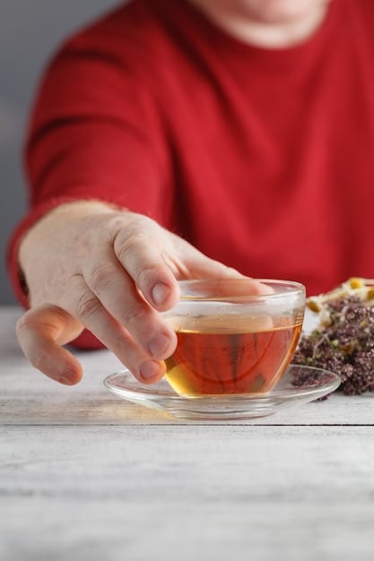A close-up shot of a mom gently holding a cup of herbal tea, focusing on the steam rising from the cup and the calming colors of the beverage. The background is softly blurred with elements of a cozy home setting, like a warm blanket and soft lighting.