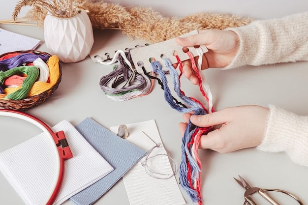 A close-up shot of a woman's hands meticulously working on a detailed embroidery project. The fabric is stretched taut in a hoop, and various colorful threads are visible.