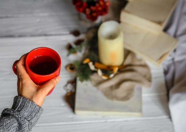 A close-up shot of a woman's hands holding a steaming mug of herbal tea, with a partially visible book next to it. The background is blurred, suggesting a peaceful, quiet moment amidst a busy day.