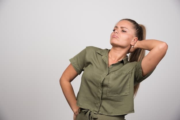 A close-up shot of a woman gently tilting her head to the side, stretching her neck. Her eyes are closed, and she has a peaceful expression on her face. Her hands are relaxed at her sides.