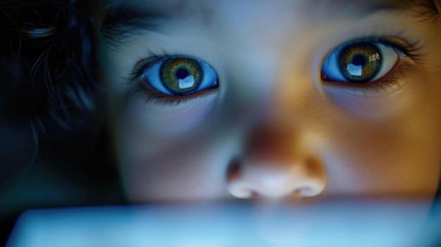 A close-up of a child's eyes looking at a digital screen. The screen emits a strong blue light, and the child's pupils are constricted.