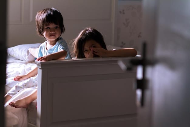 A toddler sitting up in their crib, looking tired and rubbing their eyes, indicating bedtime or naptime. The crib is in a darkened room with a soft nightlight.