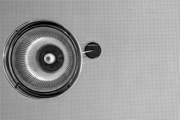 A close-up of a white noise machine emitting a soft, static-like sound wave, visually representing the sound masking effect.