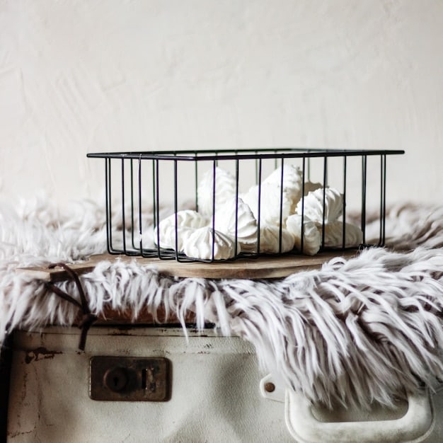 A close-up of a well-made crib with a firm mattress, a fitted sheet with a gentle pattern, and no loose blankets or toys. The side of the crib is visible, showing its solid construction and safe spacing between the slats. The lighting is soft and warm, creating a sense of safety and comfort.